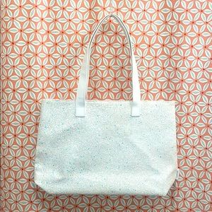 White sparkly tote bag. No laptop sleeve inside.